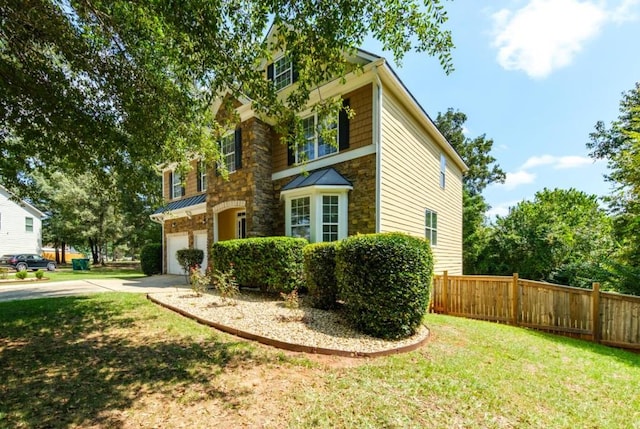 view of front facade featuring a garage, fence, concrete driveway, stone siding, and a standing seam roof