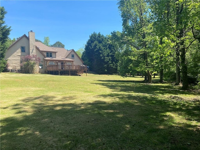 1173 Jimson Cir SE, Conyers, GA 30013 - view of green lawn with a deck