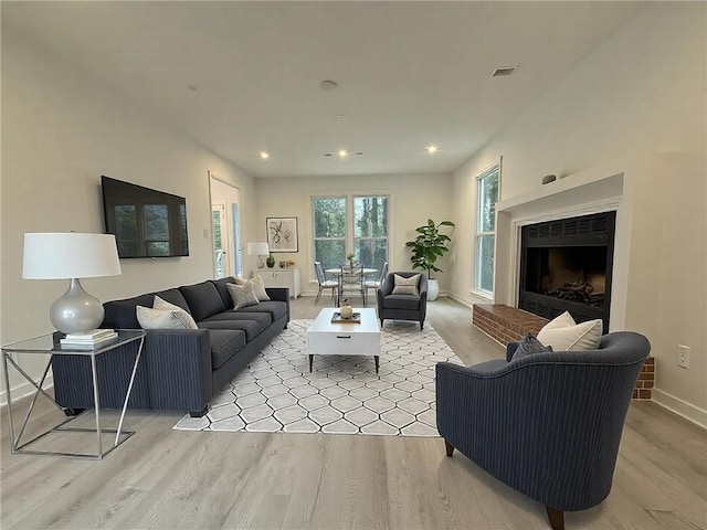 living room featuring a fireplace and light hardwood / wood-style flooring