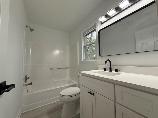 full bathroom featuring vanity, hardwood / wood-style floors, toilet, and shower / bath combination