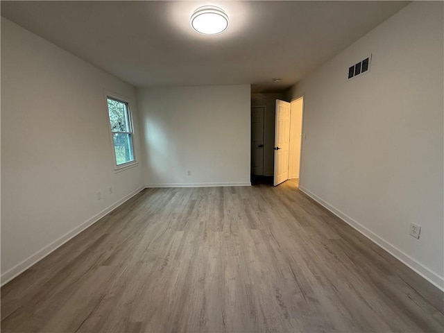 unfurnished room with light wood-type flooring