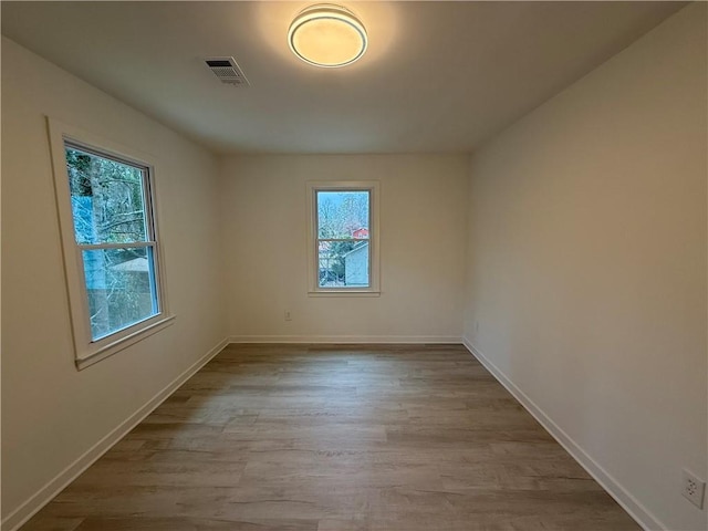 spare room with light hardwood / wood-style floors