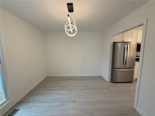 unfurnished dining area with light hardwood / wood-style flooring