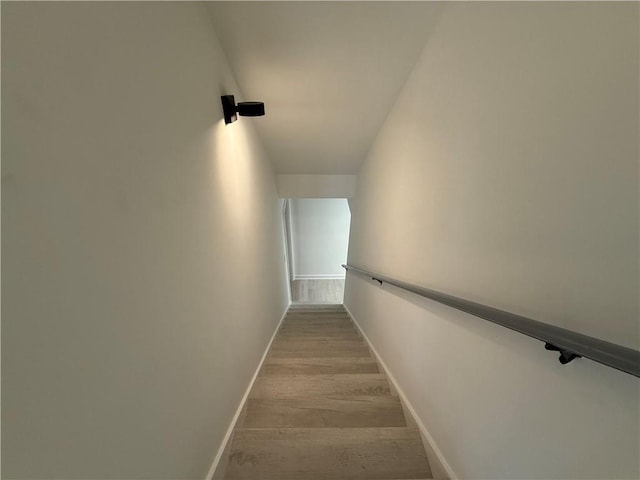 stairs featuring hardwood / wood-style floors