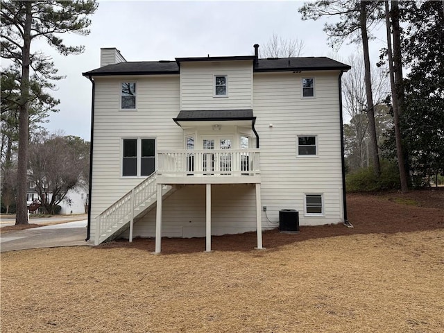 rear view of house featuring central AC and a deck