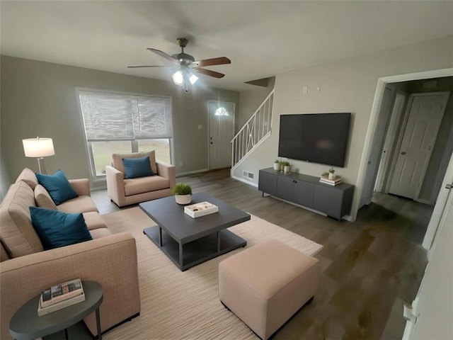 living room featuring hardwood / wood-style floors and ceiling fan