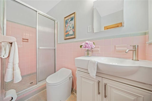 bathroom with walk in shower, vanity, tile walls, and toilet