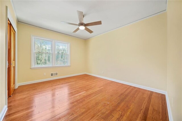 spare room featuring ceiling fan and light hardwood / wood-style flooring