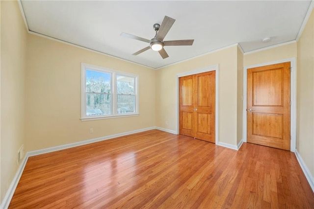 unfurnished bedroom featuring ceiling fan, light wood-type flooring, and ornamental molding