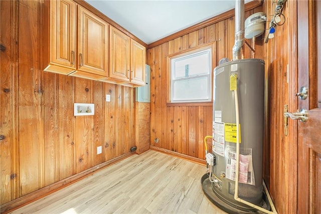 utility room with electric panel and gas water heater