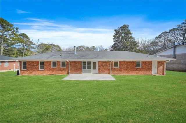 rear view of property featuring a yard and a patio