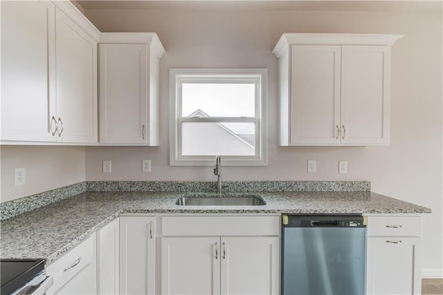 kitchen featuring stainless steel appliances, white cabinetry, and sink