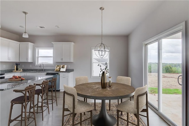 dining room with hardwood / wood-style floors and sink