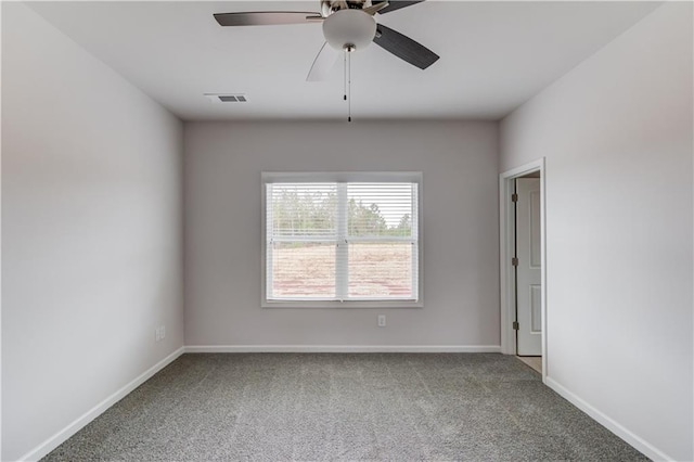 spare room featuring ceiling fan and carpet floors