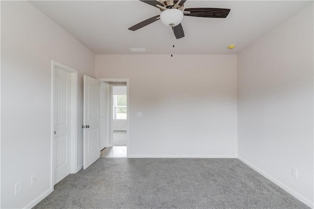 unfurnished room with light colored carpet and ceiling fan