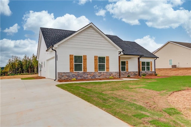 view of front of property with a front yard and a garage