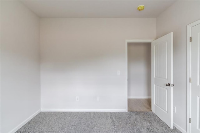 spare room featuring light colored carpet