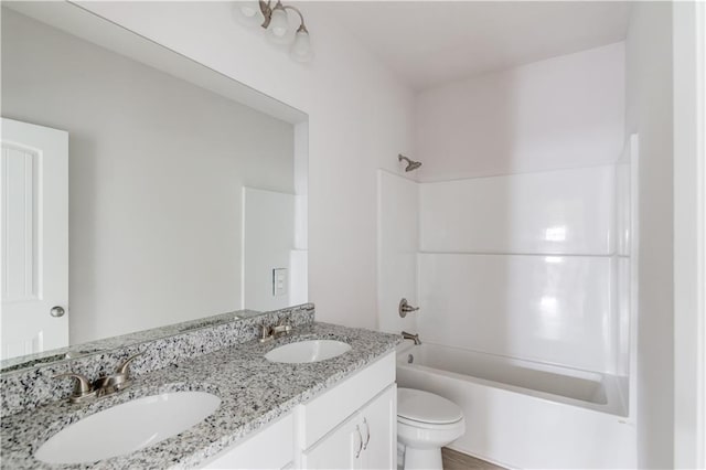 full bathroom featuring vanity, bathtub / shower combination, and toilet