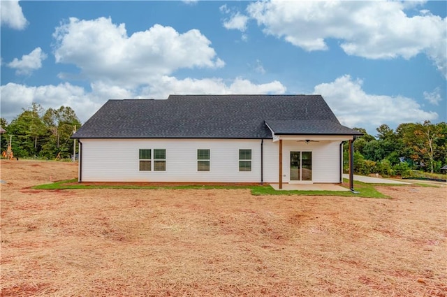 rear view of house featuring ceiling fan and a patio area