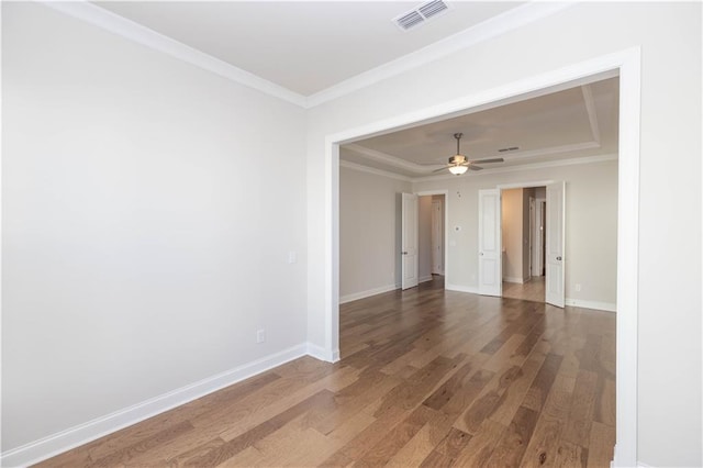 spare room with crown molding, ceiling fan, and wood-type flooring