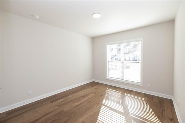 spare room featuring dark hardwood / wood-style flooring