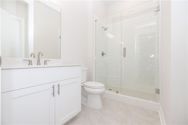 bathroom with vanity, walk in shower, tile patterned floors, and toilet