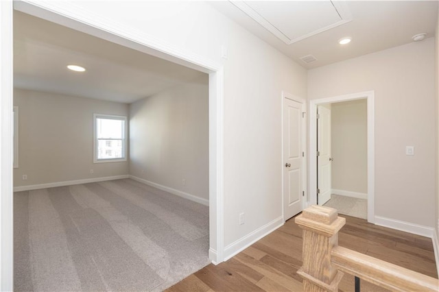 hallway with light hardwood / wood-style floors