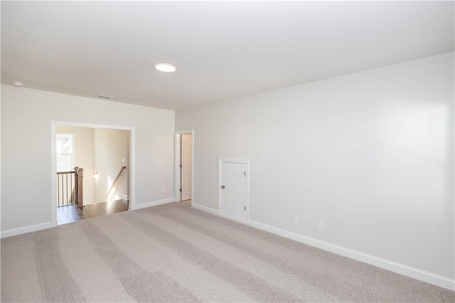 spare room with light carpet