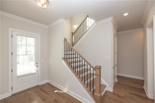 entryway featuring hardwood / wood-style flooring and ornamental molding