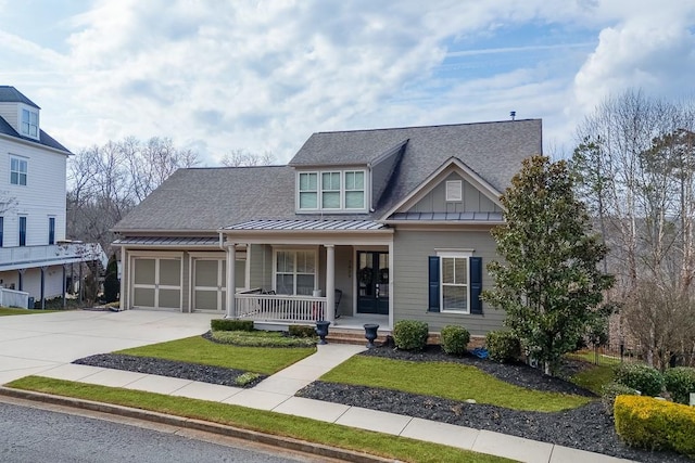 view of front of home featuring roof with shingles, a porch, board and batten siding, a standing seam roof, and driveway