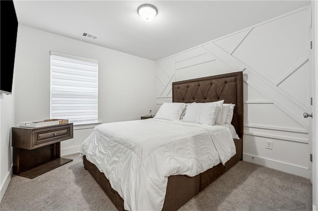 bedroom with light carpet, visible vents, and baseboards