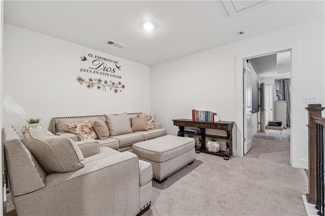 living area with light carpet and visible vents