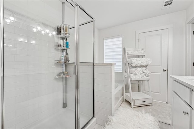 bathroom featuring visible vents, a garden tub, vanity, and a shower stall