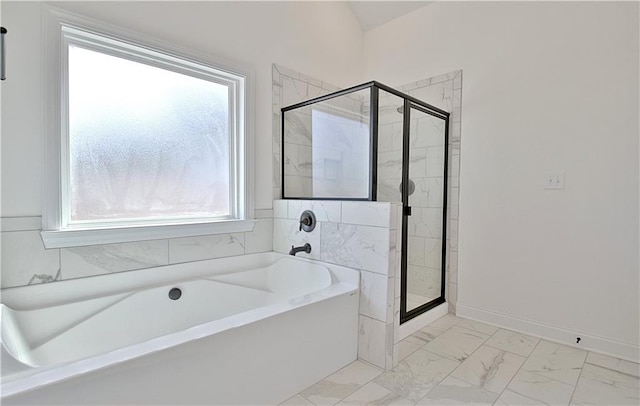 bathroom with shower with separate bathtub and plenty of natural light