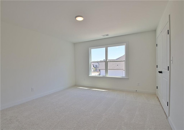 empty room featuring light colored carpet