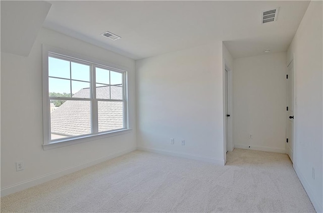 unfurnished room featuring light colored carpet