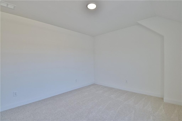 unfurnished room featuring light colored carpet