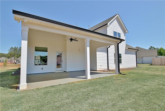 rear view of property featuring a lawn, a patio area, and ceiling fan