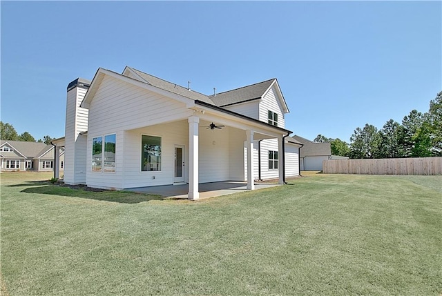 back of house featuring ceiling fan, a patio area, and a lawn