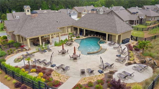 view of swimming pool with pool water feature, a patio, and a hot tub