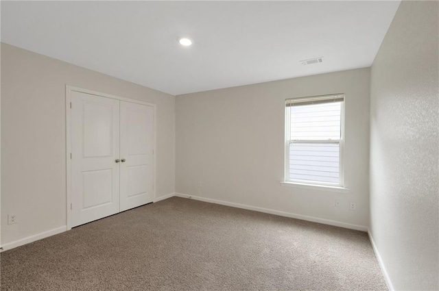 10814 Wheeler Trce, Hampton, GA 30228 - unfurnished bedroom with carpet flooring, baseboards, a closet, and recessed lighting