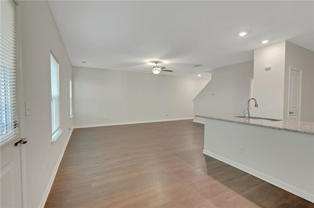 10814 Wheeler Trce, Hampton, GA 30228 - unfurnished living room with a ceiling fan, a sink, dark wood-style flooring, baseboards, and recessed lighting