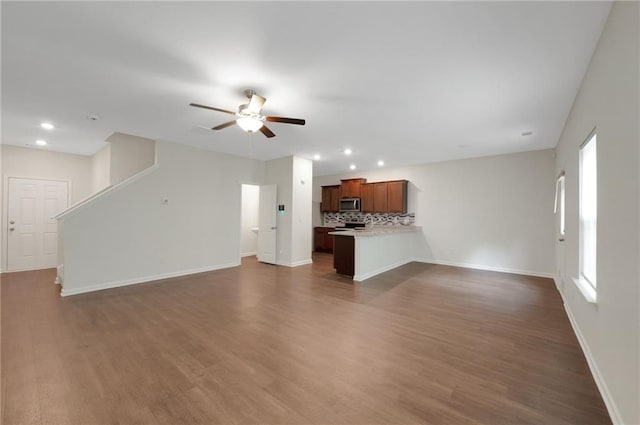 10814 Wheeler Trce, Hampton, GA 30228 - unfurnished living room with ceiling fan, baseboards, dark wood finished floors, and recessed lighting