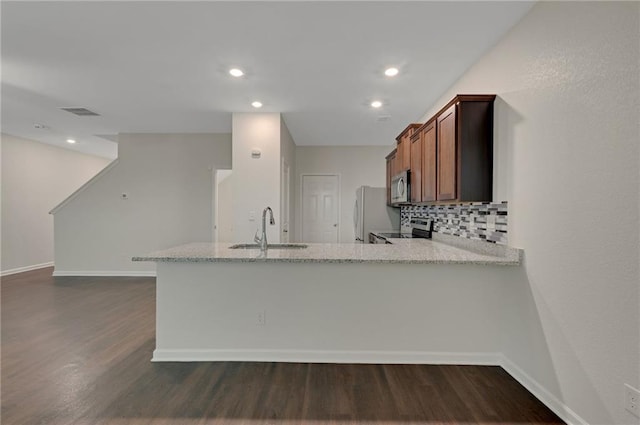 10814 Wheeler Trce, Hampton, GA 30228 - kitchen with appliances with stainless steel finishes, a sink, dark wood-style flooring, decorative backsplash, and recessed lighting