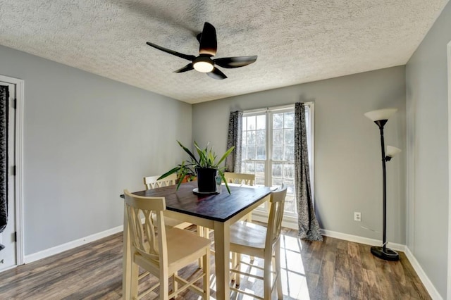 dining room featuring a textured ceiling, dark hardwood / wood-style floors, and ceiling fan