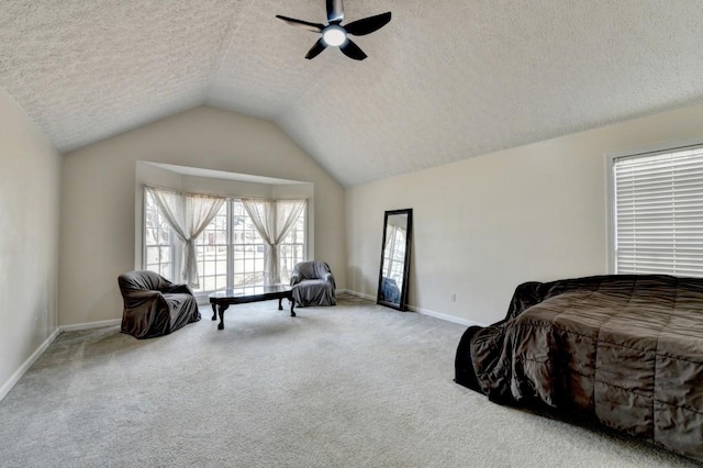 carpeted bedroom featuring ceiling fan, a textured ceiling, and vaulted ceiling