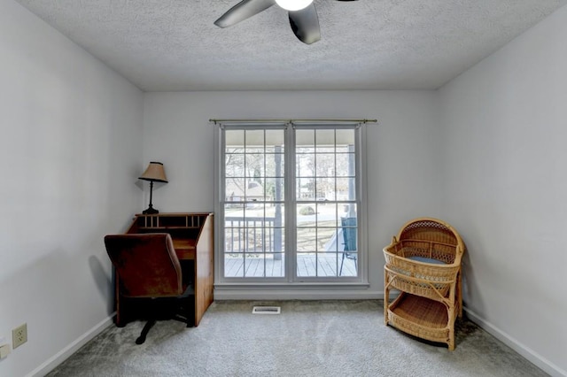 sitting room with carpet, a textured ceiling, and ceiling fan