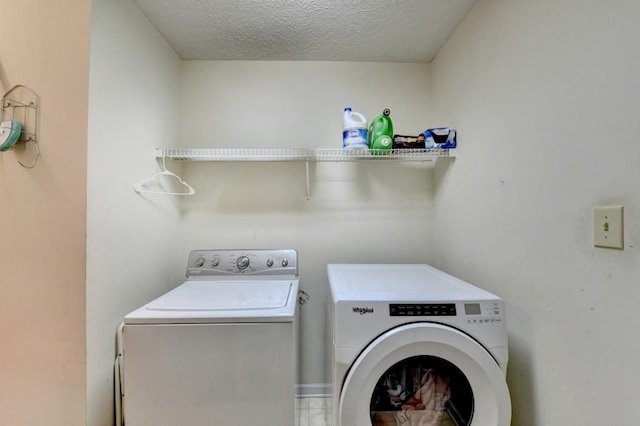 washroom featuring a textured ceiling and separate washer and dryer