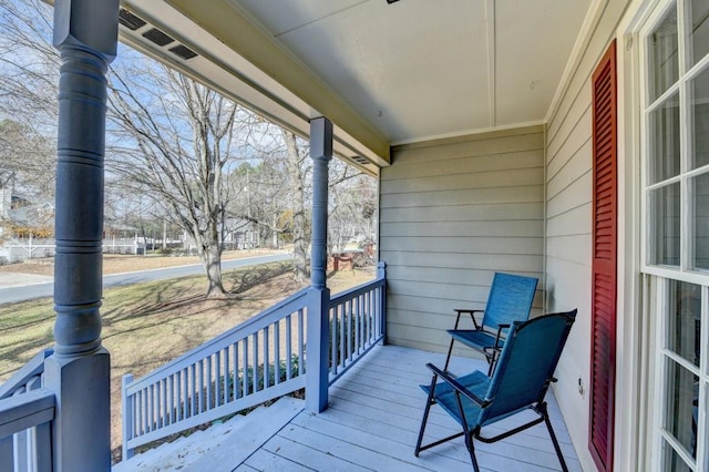 wooden terrace featuring covered porch