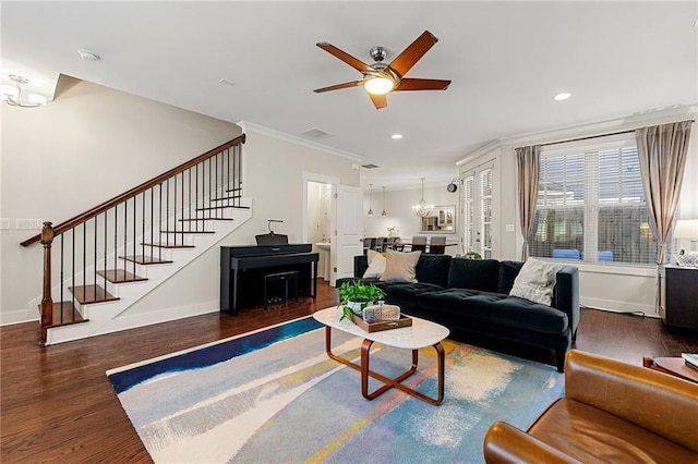 living area with stairway, wood finished floors, and baseboards